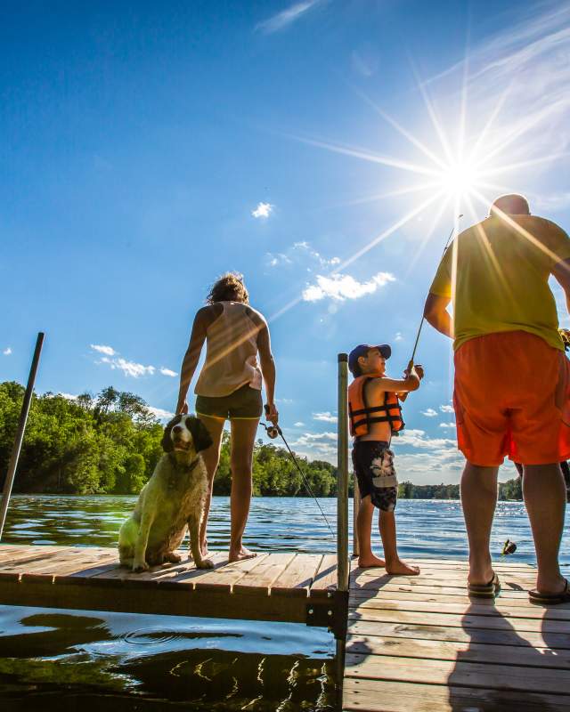 Family fishing on a dock on Long Lake