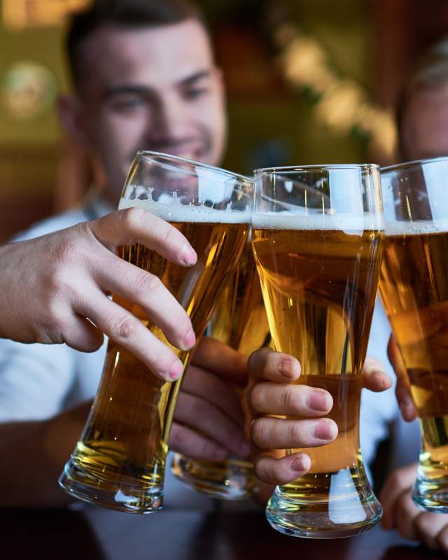 Guys Cheersing with Beer