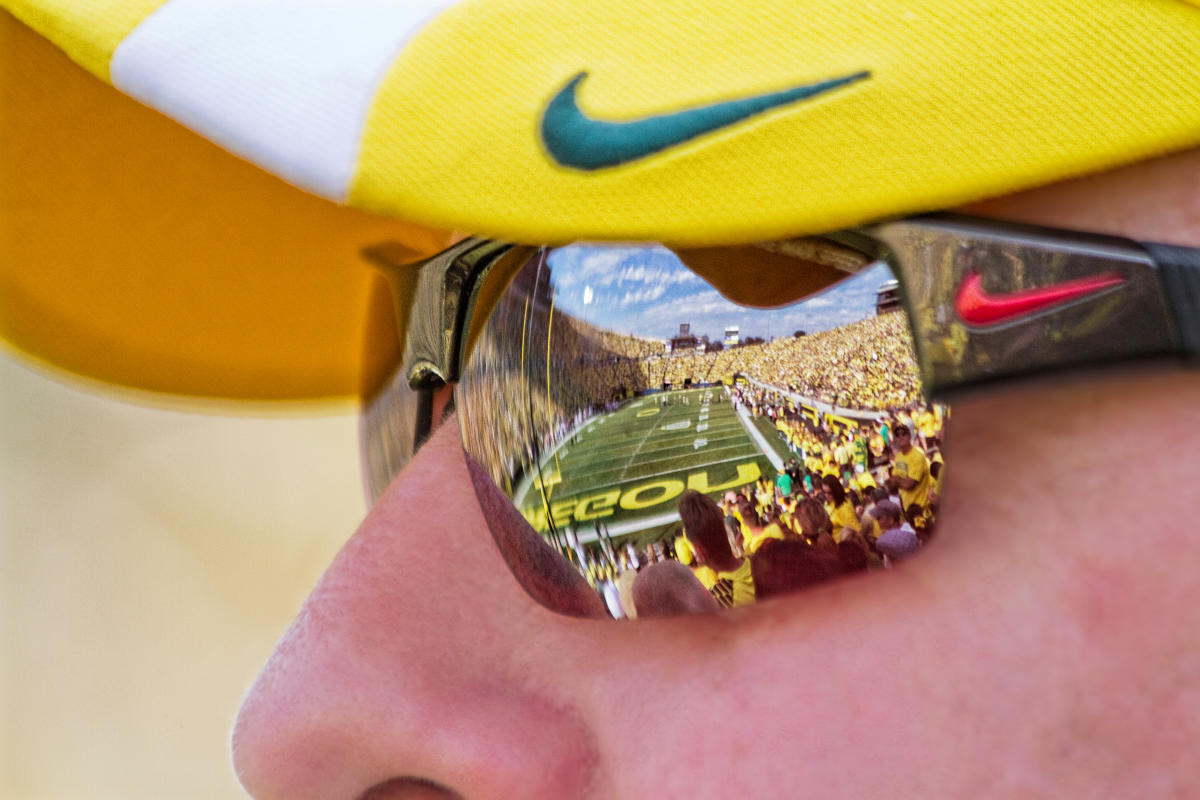 Yellow Visor with Nike Swoosh and sunglasses reflecting autzen field by David Putzier