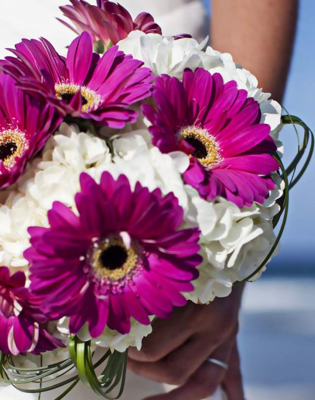 A bride holds her bouquet for a beach wedding in the Outer Banks