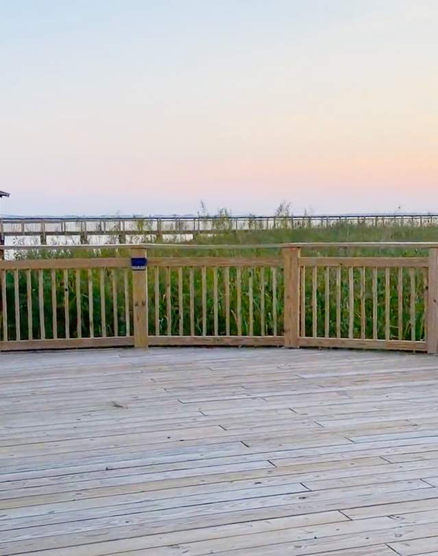 A golden sunset over the Roanoke Sound at The Soundside Boardwalk and Gazebo in Nags Head, NC.