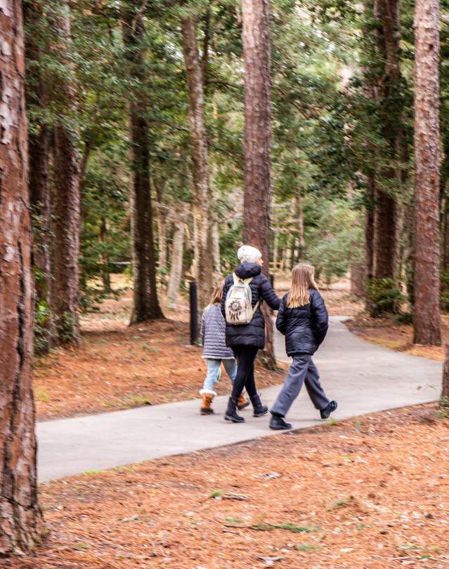 A mom and kids walk through the Fort Raleigh National Historic Site on the Outer Banks.