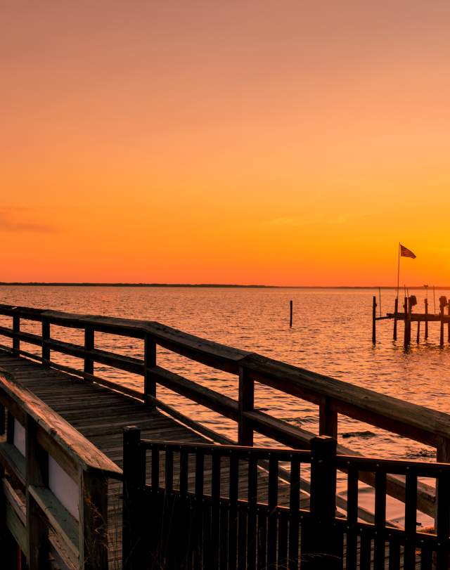 Pier extending into the James River at sunset