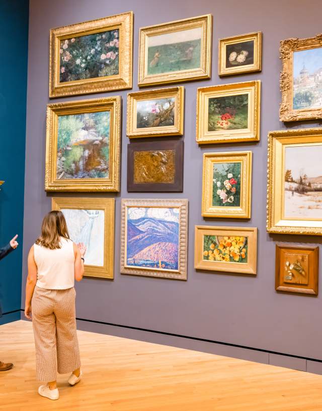 Two people look at art in a gallery at Crystal Bridges Museum of American Art
