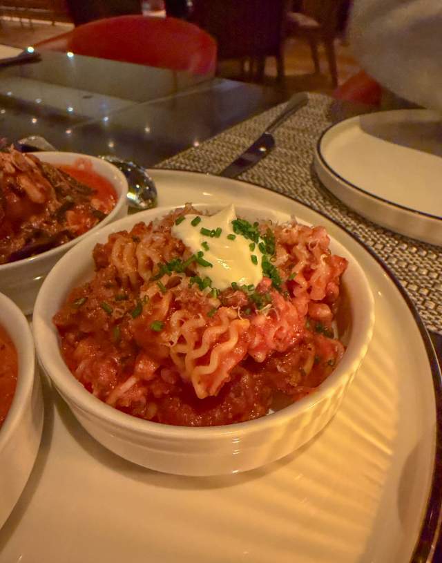 A bowl with a heaping serving of Radiatore pasta in red sauce.
