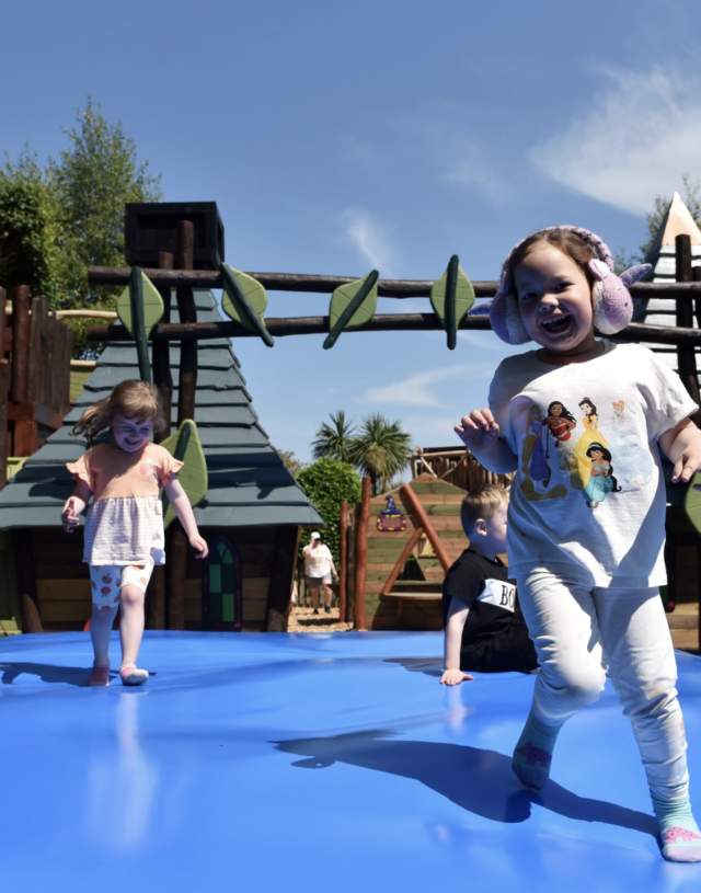 children playing at a big inflatable pillow