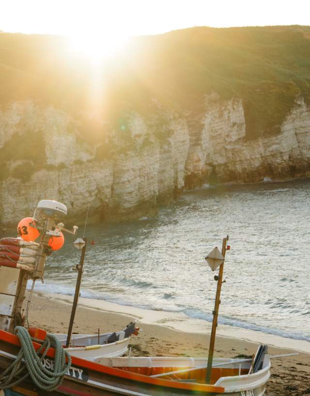 The sunrise at North Landing, Flamborough with the sun starting to appear above the cliff top.