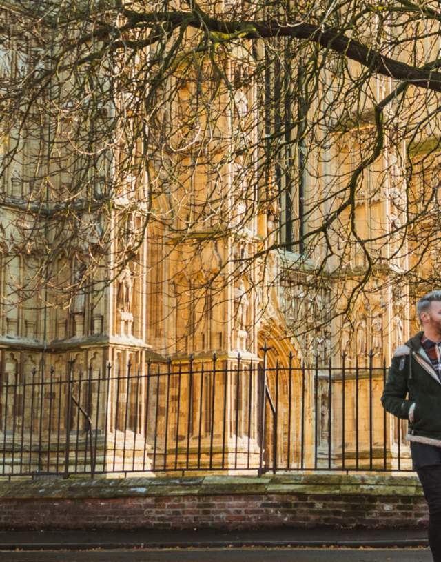 Two people walking in front of Beverley Minster