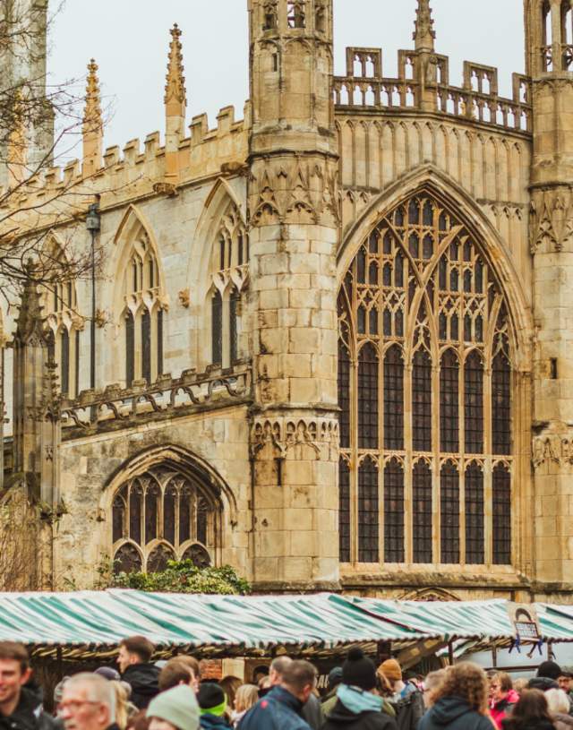 Market stalls as part of the Beverley Festival of Christmas, with St Mary's Church in the background.