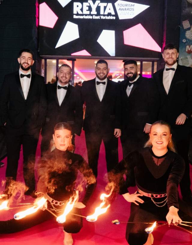 guests and fire performers on the pink carpet at the REYTAs 2024