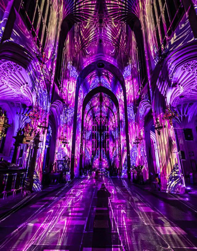 Luxmuralis light show of purple light and images on cathedral walls