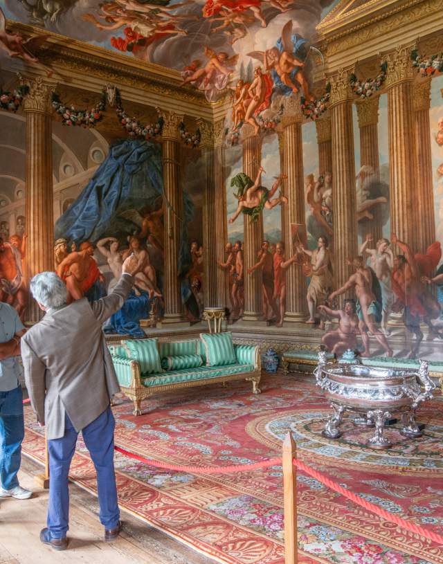 A man and woman take a guided tour around Burghley House