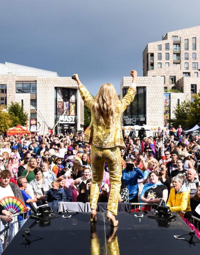 Southampton Pride mainstage with person in a gold suit and crowd