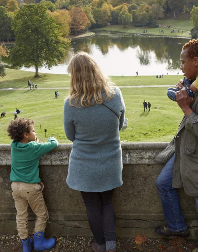 A family enjoying Claremont Landscape Garden, Surrey