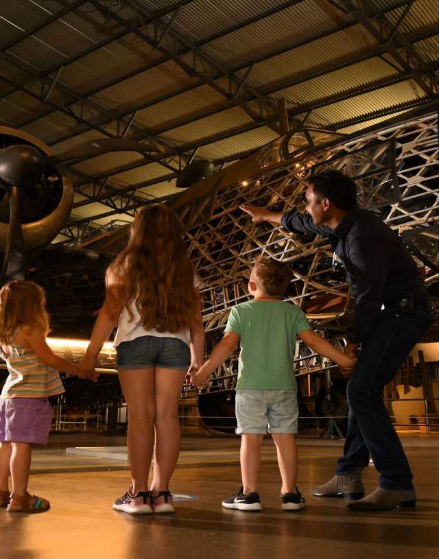 A family looking up at an aircraft at Brooklands Museum