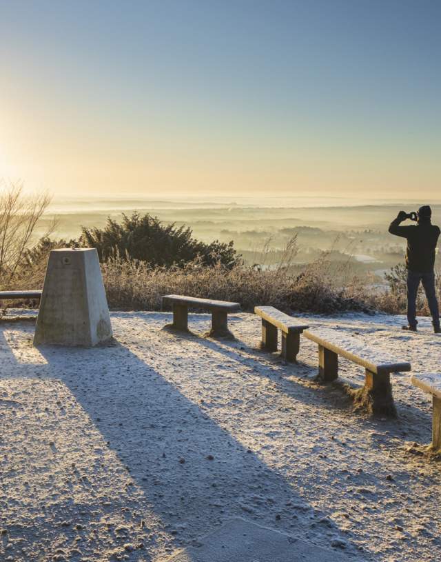 Man taking photos of the sunrise at Leith Hill Surrey