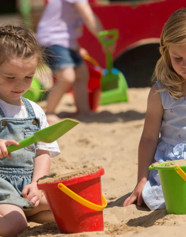 Children enjoying outdoor fun in the sand pits at Godstone Farm
