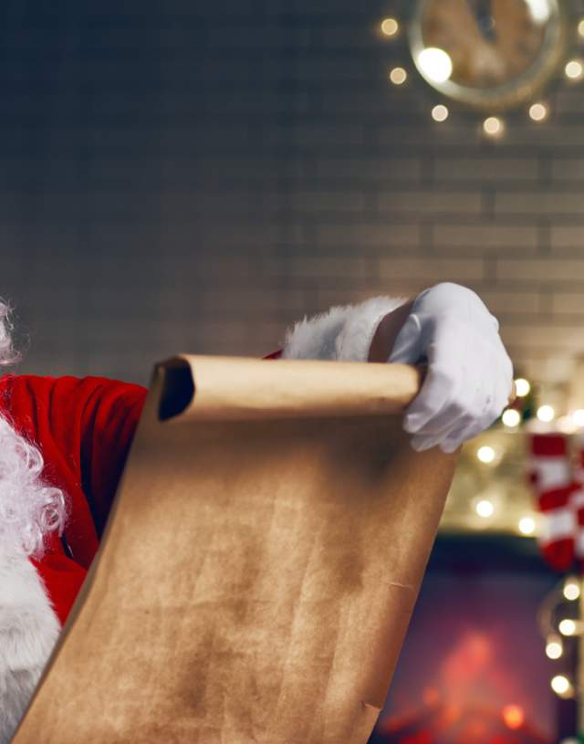 Father Christmas by a Christmas Tree