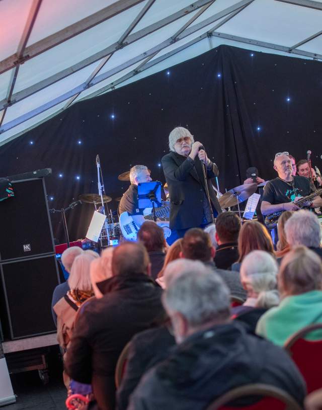 Sir Karl Jenkins singing on stage at Swansea Jazz Festival