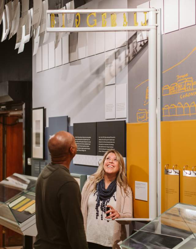 Couple exploring the Dylan Thomas Centre exhibition in the dylan thomas centre