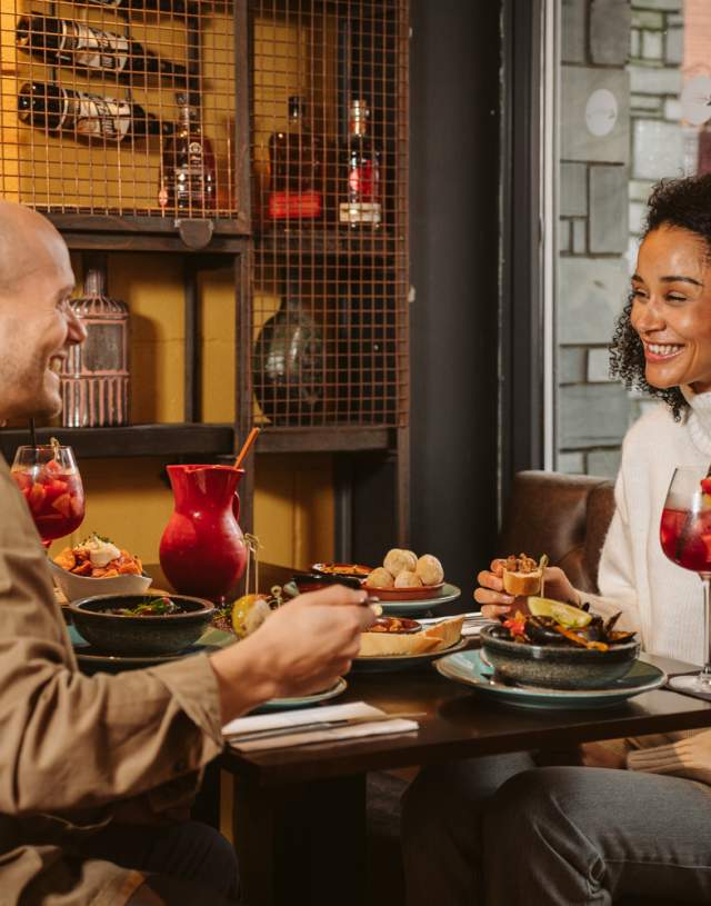 Couple enjoying evening meal and cocktails