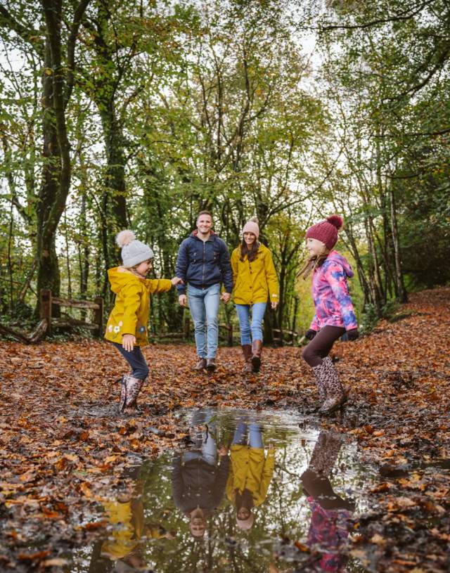 A family walking through Penllegare woods