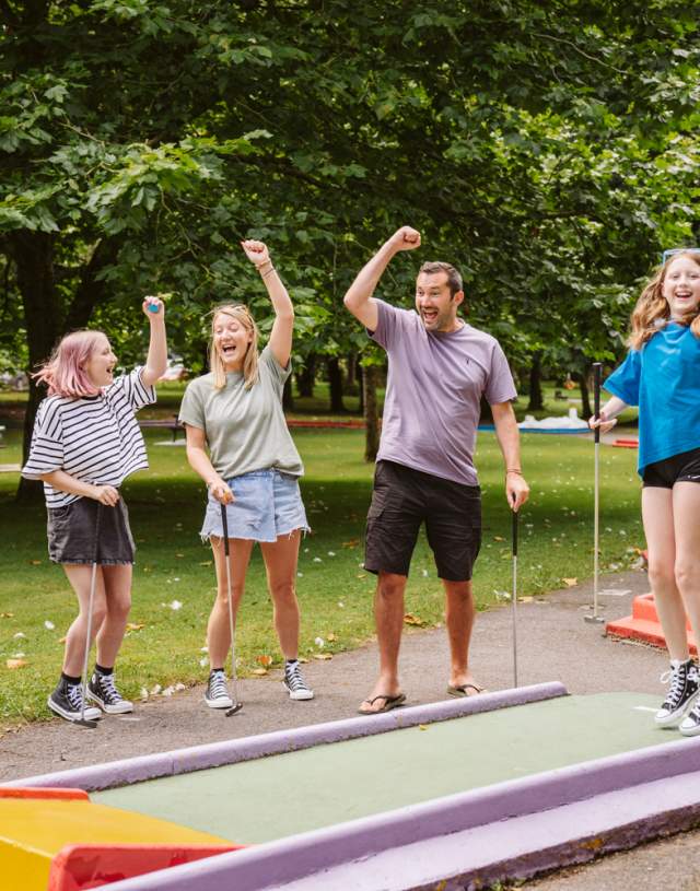Family playing mini golf in Singleton Park
