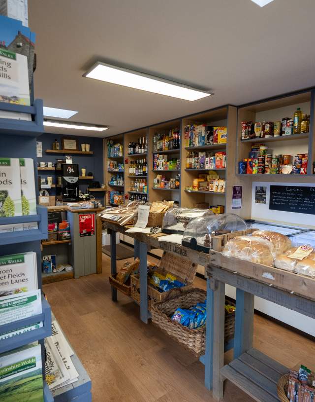 a village shop with local products and maps on the walls