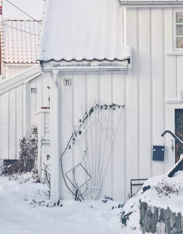 White wooden houses in the snow in Risør, Norway