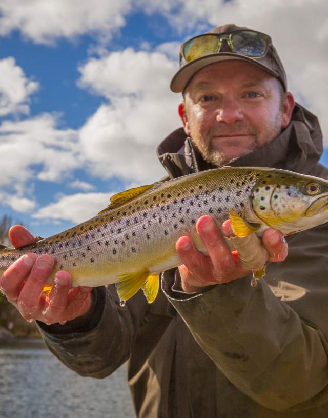 A guy holding a sea trout