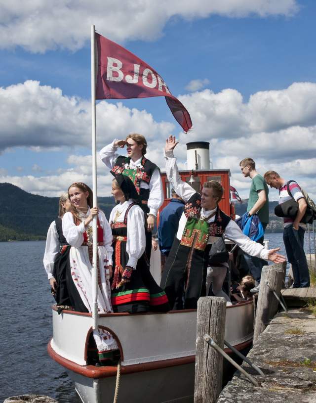 People wearing national costumes on board the old steam boad Bjoren. Photo