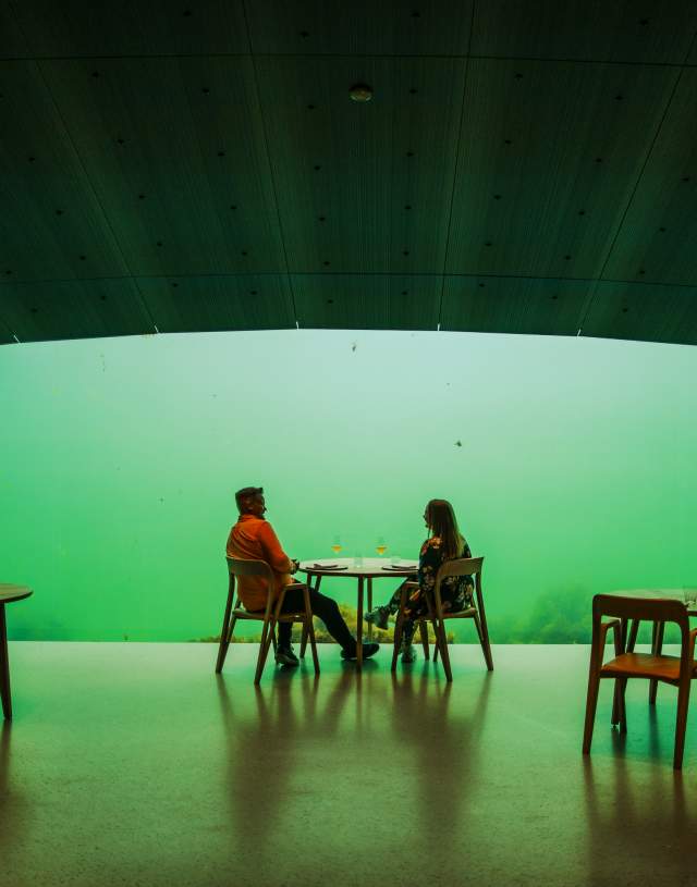 Couple sitting in restaurant Under underwater