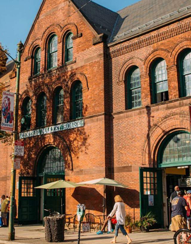 Exterior shot of Central Market House in autumn with people walking along the sidewalk