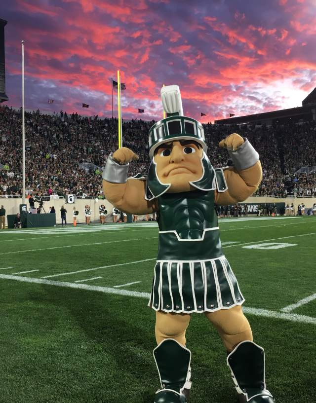 Michigan State University's Mascot, Sparty, standing on the turf of Spartan Field.