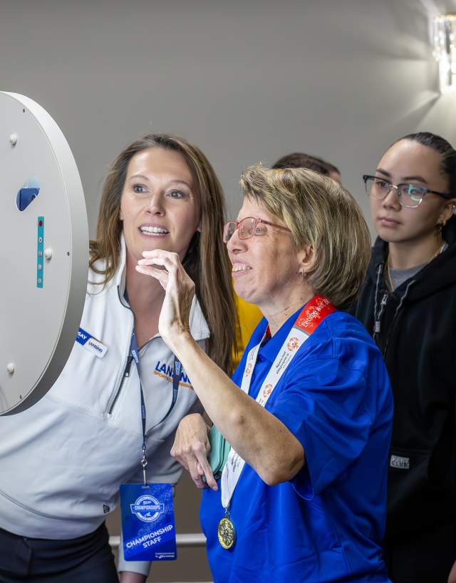 Lindsay Fast is helping a participant set up the selfie station at the NAIA National Championship