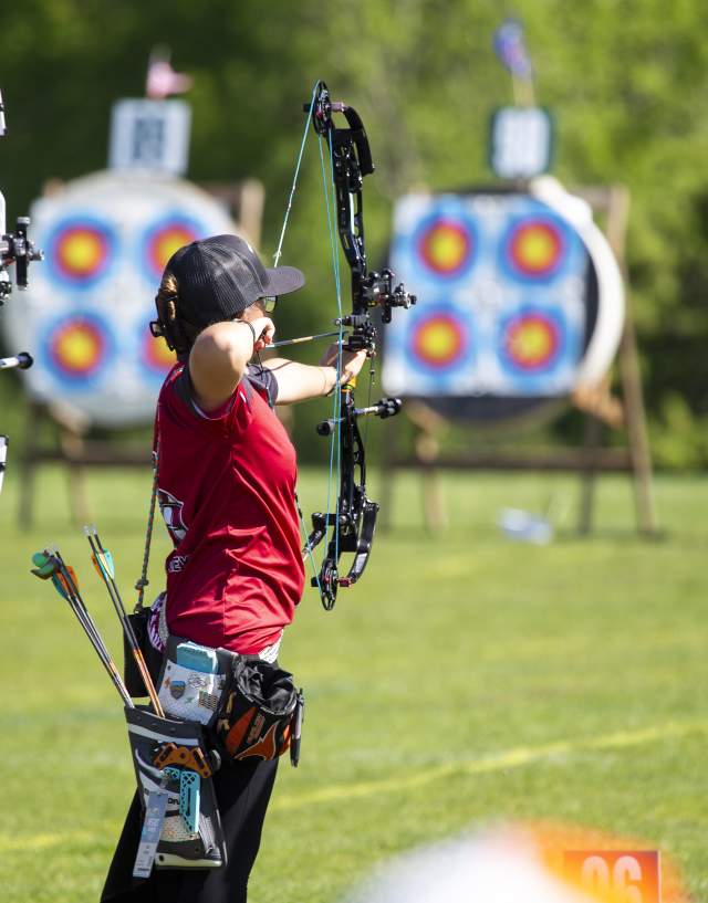 Three archers lined up to shoot targets