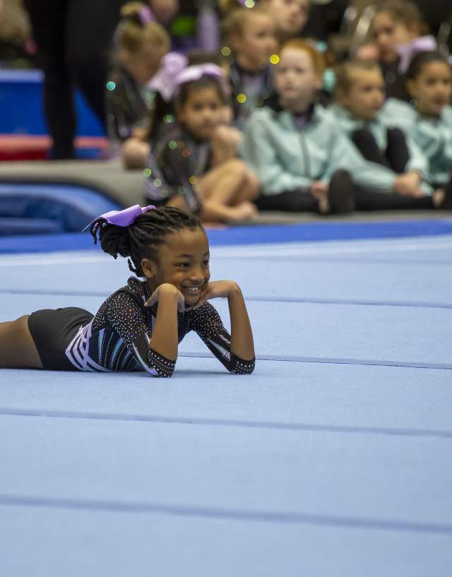 Athlete posing at the end of her performance on the mat
