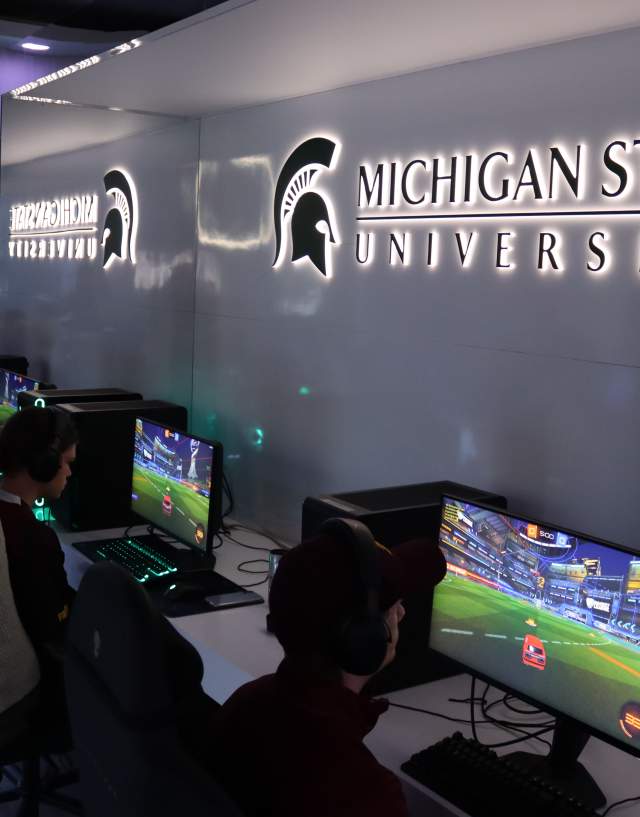 Computers set up with athletes competing in an Esport event