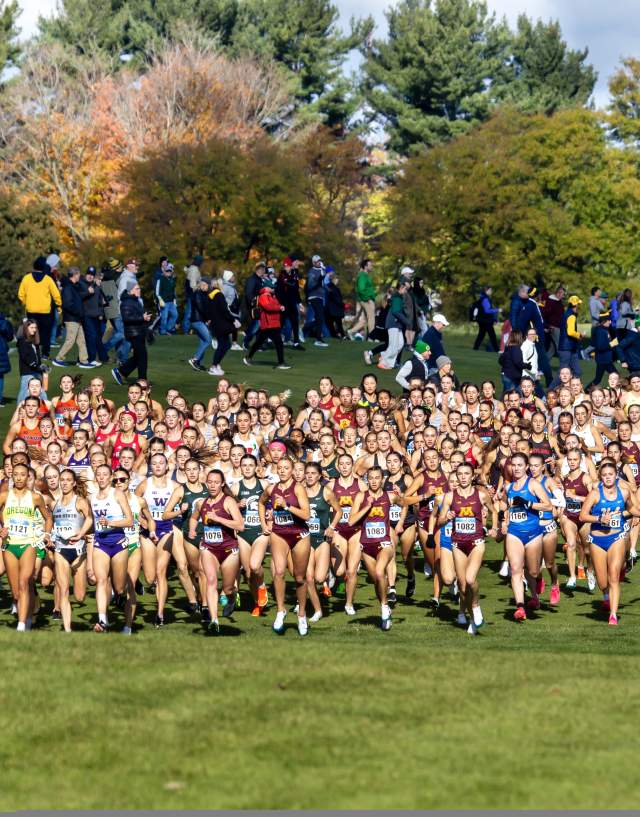 A group of women running at Forest Akers for the Big Ten Cross Country Championships