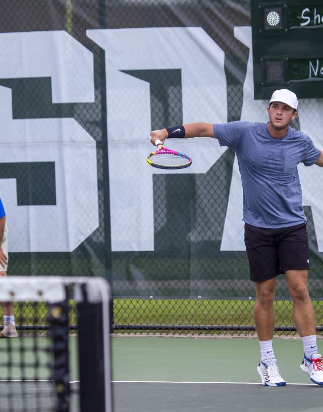 Tennis player hitting the ball across the net