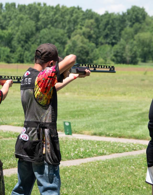 Three athletes lining up to shoot clay targets at the USA High School Clay Target Championships