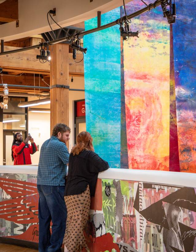 A small crowd is looking at an art piece.