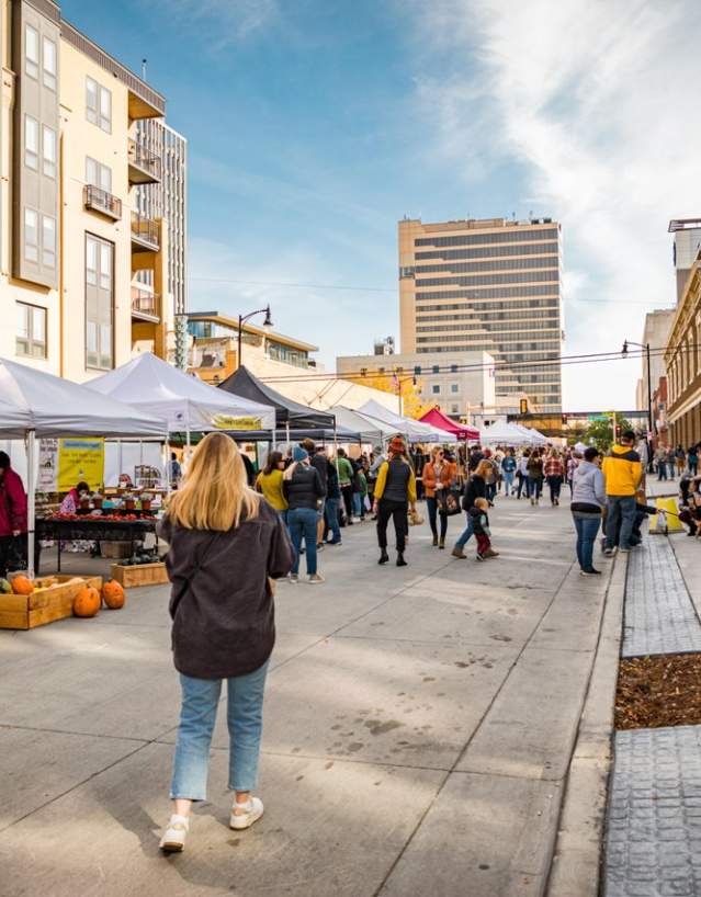 women walking through downtown street during a market