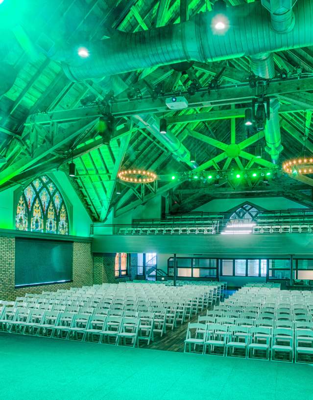 interior of Sanctuary Events Center lit up with green lighting.