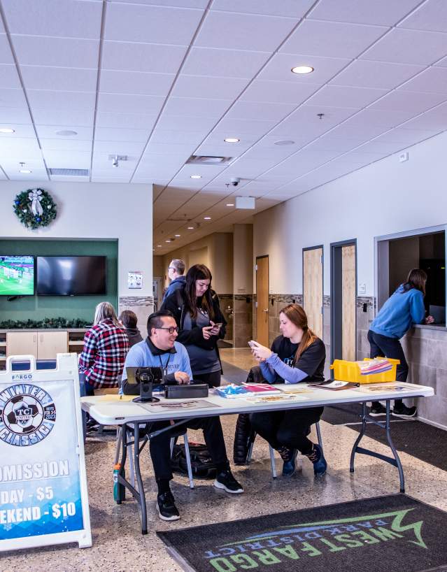 lobby of rustad recreation center with registration for a soccer game