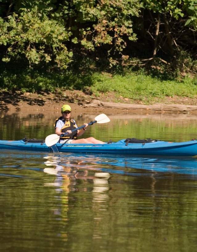 Man paddling a canoe in Potomac River, Maryland