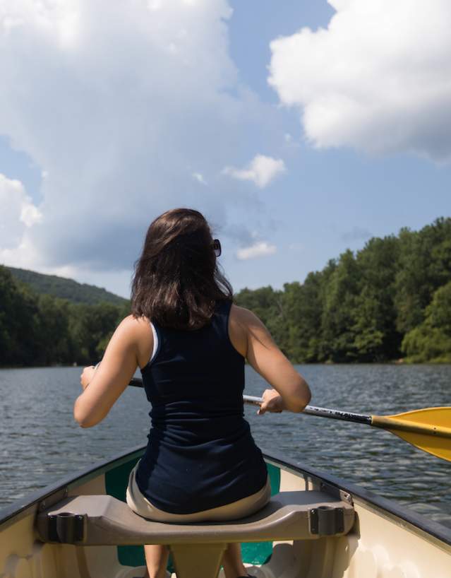 Woman paddling a canoe in the water in Frederick, MD