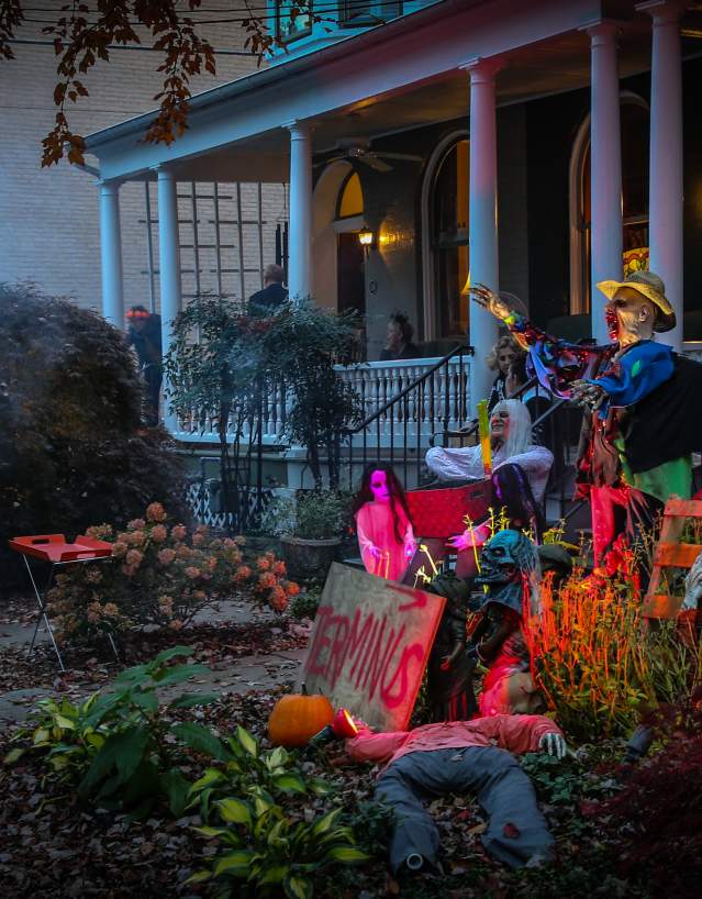 Kids trick-or-treating at a spooky house