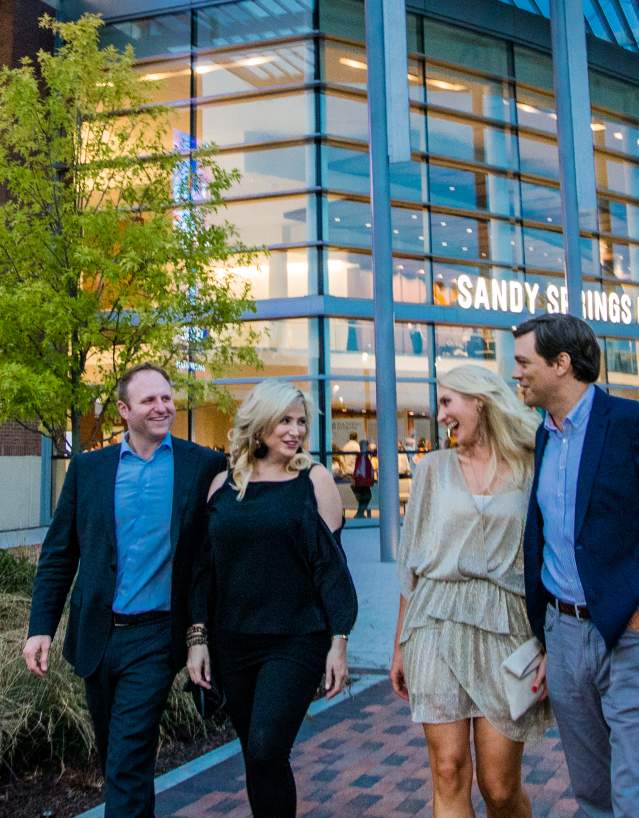 Two couples walking in front of the Sandy Springs Performing Arts Center at City Springs