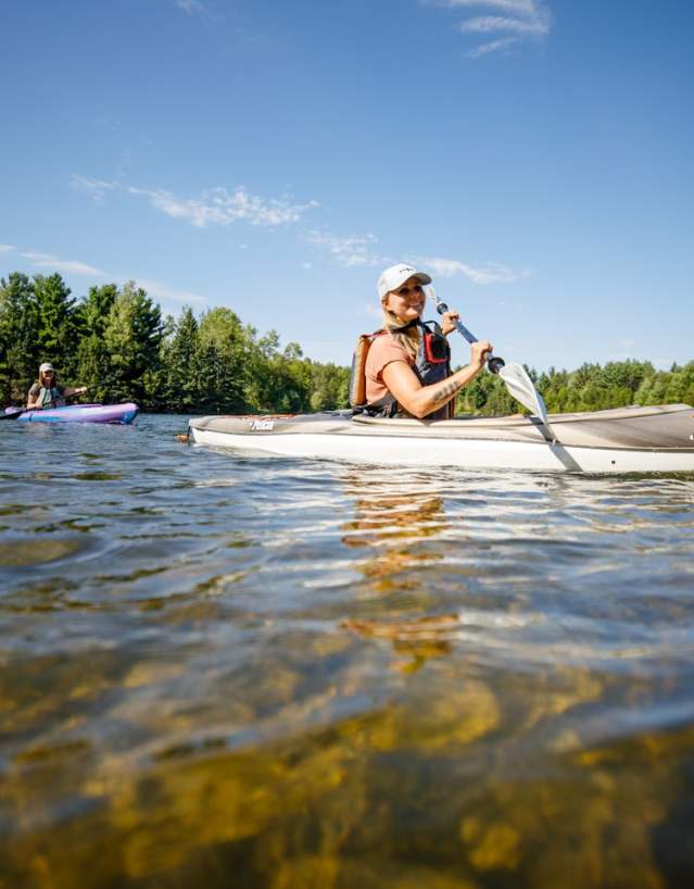 Two women kayaking along the river